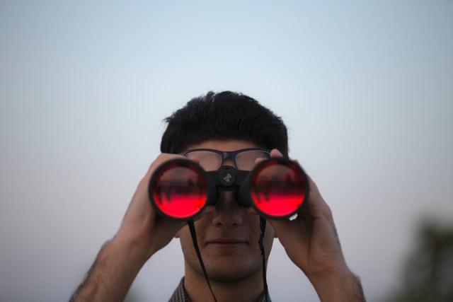 Man looks through binoculars